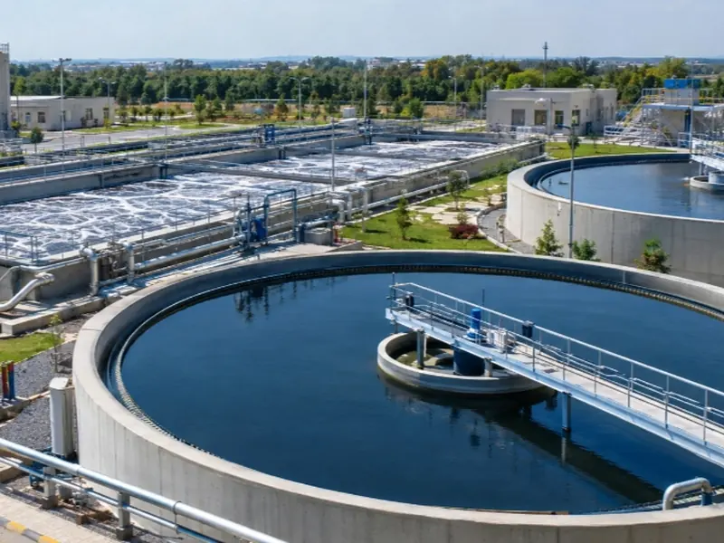 Wastewater treatment plant with aeration basins and a large circular clarifier